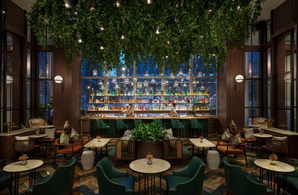 hotel-lobby-bar-design-featuring-plants-and-warm-decor
